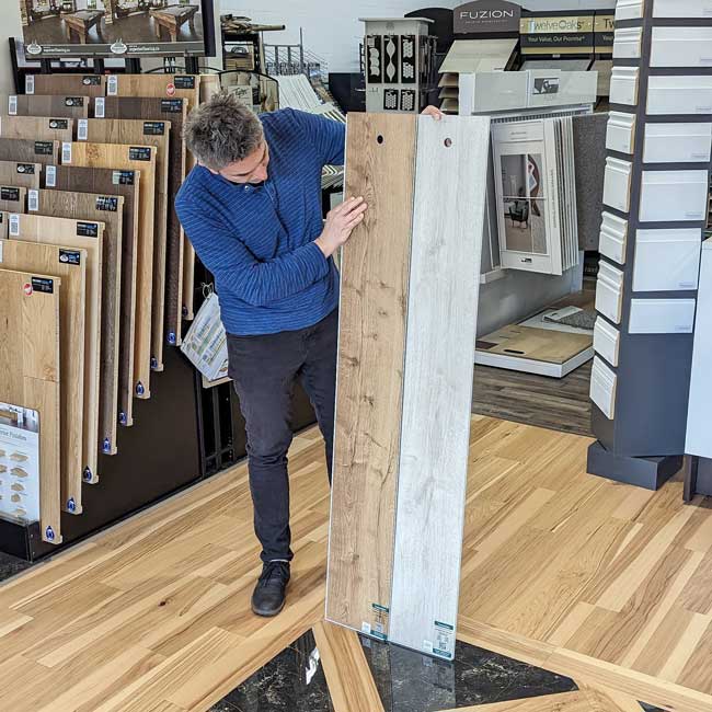 Customer browsing laminate flooring options in store